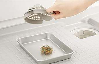排水口カバーを外してゴミを捨てる様子